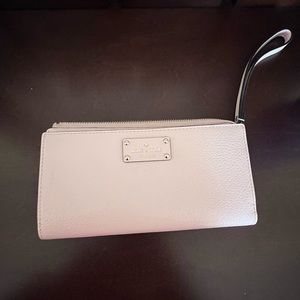 Blush pink Kate spade wristlet with pockets and zippered pouch. Never used!